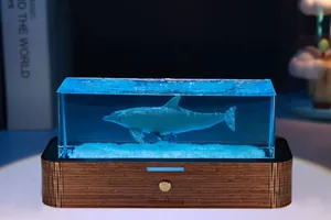 Dettaglio di una luce notturna in resina a forma di delfino con base in legno
