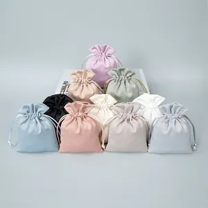 Assortment of elegant satin drawstring pouches in multiple colors for jewelry storage