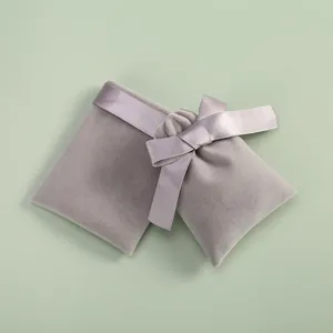 Detailed macro view of elegant lavender velvet jewelry pouch with silk ribbon bow