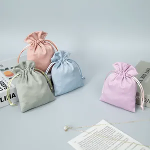 Detail view of colorful sateen drawstring jewelry pouches with silk-like texture