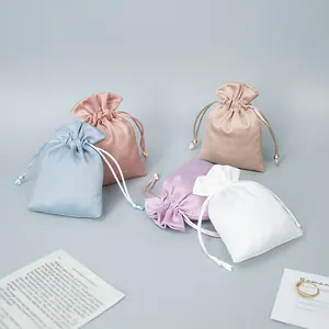 Detail view of colorful satin drawstring pouches for jewelry storage and protection.