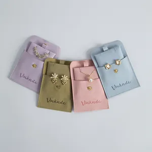 Microfiber jewelry storage pouches in four colors with snap buttons and inner inserts