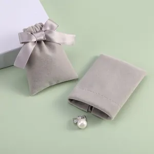 Luxury grey velvet jewelry drawstring pouch with elegant satin bow and pearl accessory