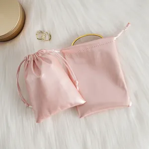 Detail of pink PU leather drawstring pouches showing soft texture on faux fur