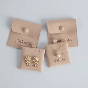 Detailed view of beige microfiber jewelry pouches and inserts with snap button closure.
