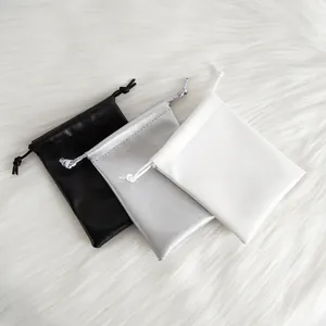 Detailed view of high quality PU leather drawstring pouches in black, silver and white colors