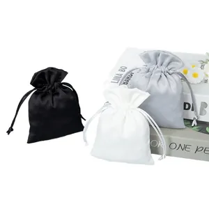 Elegant satin drawstring gift pouches for jewelry in black white and grey