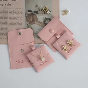 Close-up of pink microfiber jewelry pouches with snap closure and necklace card