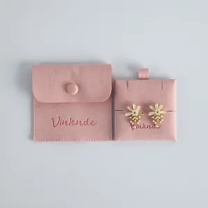 Elegant pink suede snap jewelry pouch with decorative floral drop earrings storage set