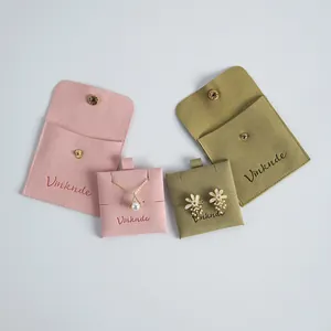 Professional double-sided velvet jewelry pouches with snap button closures in pink and green