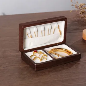 Close-up of premium black walnut solid wood jewelry box with white velvet interior