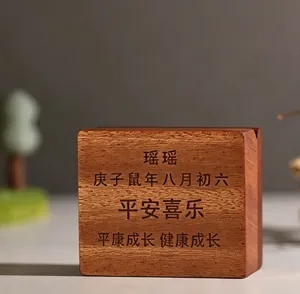 Detailed macro view of laser engraving on a natural wooden baby keepsake box for teeth