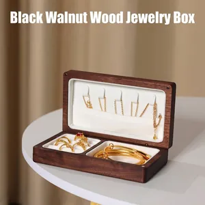 Detail of premium black walnut solid wood jewelry box with soft white velvet lining