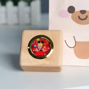 Close-up of wooden baby souvenir box with circular gold frame for custom photo