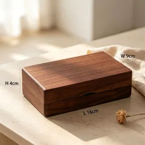 Detailed macro view showing the size of a solid black walnut wood jewelry box, 16x9x4cm.