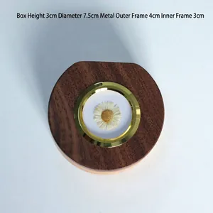 Detailed view of wooden baby keepsake box showing dimensions and dried flower inlay.