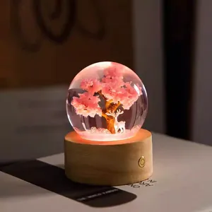 Creative warm glow crystal ball night light with pink tree and deer on a wooden base
