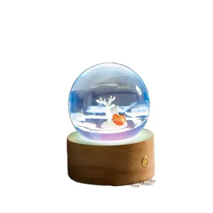 Romantic crystal ball night light featuring a white deer and love heart on a wooden base