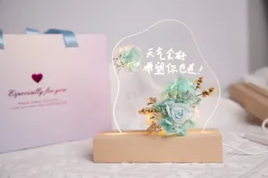 Detail of preserved flower night light with acrylic writing board and warm LED glow.