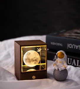 Close-up detail view of walnut wood night light with 3D moon and astronaut inside