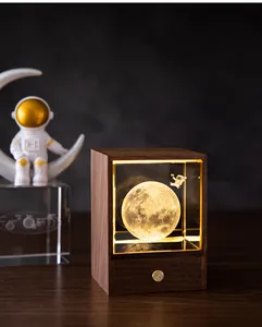 Detail of walnut wood night light showing luminous moon inside crystal glass