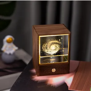 Detail of black walnut night light featuring laser-engraved galaxy crystal cube.