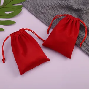 Detalle de dos bolsas de terciopelo rojo con cordón para empaque de joyería de lujo