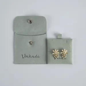 Mint green suede jewelry pouch with snap button and matching display card for rings and earrings.