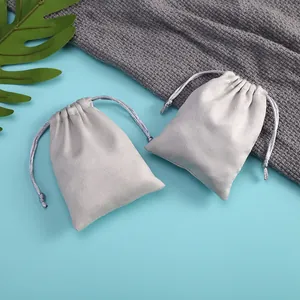 Close-up detail of soft grey velvet drawstring pouches for jewelry storage
