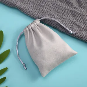 Detailed macro view of soft grey velvet drawstring pouch for jewelry and accessory storage