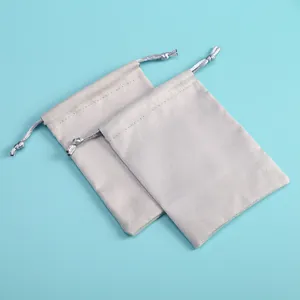 Macro view of two grey velvet drawstring pouches for jewelry and electronics storage