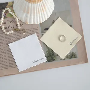 Close-up macro view of white and beige microfiber cleaning cloths for jewelry and watches