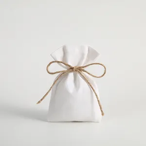 Small white canvas drawstring pouch with jute rope bow for jewelry gift packaging