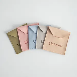 Minimalist microfiber jewelry pouches in pastel colors with envelope flap closure
