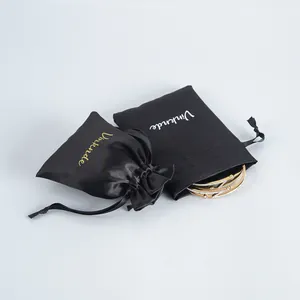 Premium Schwarze Satin Schmuckbeutel mit eleganten goldenen Armreifen im Detail