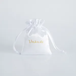 Elegant white satin drawstring jewelry pouch with gold Vinknde branding for storage