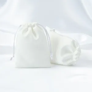Pair of elegant white velvet drawstring pouches for jewelry and luxury storage