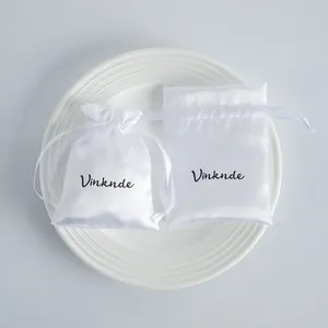 Elegant white satin drawstring jewelry pouches for storage and luxury gift packaging