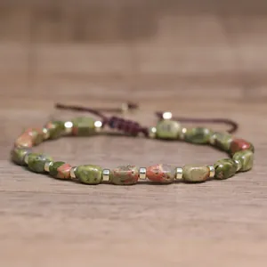 Close-up detail of natural unakite stone beads and golden spacers on handmade bracelet