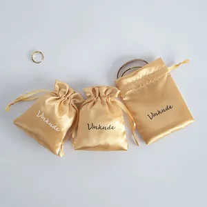 Three champagne satin drawstring pouches in various sizes for luxury jewelry storage