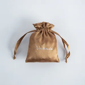 Close-up detail of smooth brown satin drawstring pouch for luxury jewelry packaging