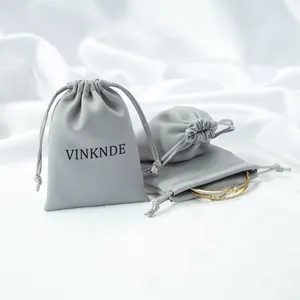 Grey satin drawstring storage pouch showing luxury jewelry organization detail view