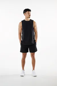 Male model wearing a black athletic sleeveless tank top and matching shorts in a studio