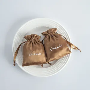 Detail view showing the silky texture of bronze satin drawstring jewelry gift bags