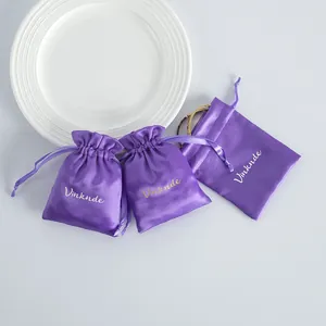Detail view of purple satin drawstring bags for jewelry storage and gift packaging.