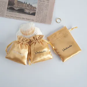 Luxury gold satin drawstring pouches for jewelry storage with smooth texture
