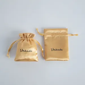 Elegant gold satin drawstring storage pouches for jewelry with a smooth silk-like finish