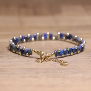 Detailed shot of blue lapis Tila bead bracelet with gold accents and lobster clasp