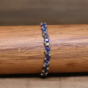 Detailed view of handmade TILA bead woven bracelet with blue and gold accents
