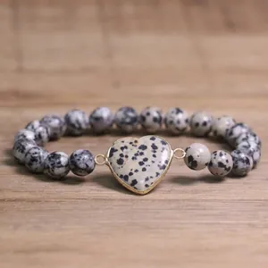 Close-up of Dalmatian Jasper beaded bracelet with a heart-shaped stone centerpiece